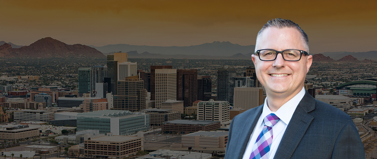 Attorney Trent R. Buckallew in front of a vibrant cityscape